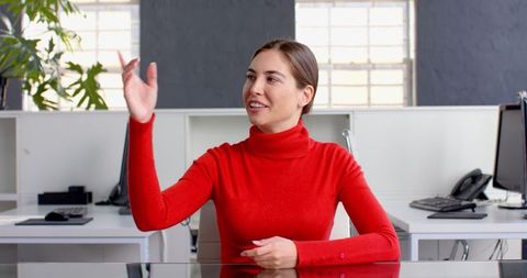 Confident Businesswoman Engaging Discussion at Office Desk - Download Free Stock Images Pikwizard.com