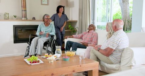 Seniors Bonding Over Snacks in Cosy Living Room