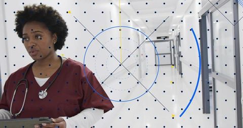 African american nurse walking hospital corridor checking tablet telehealth hud overlay
