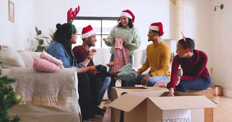 Festive volunteers sorting clothing donations for holiday charity drive