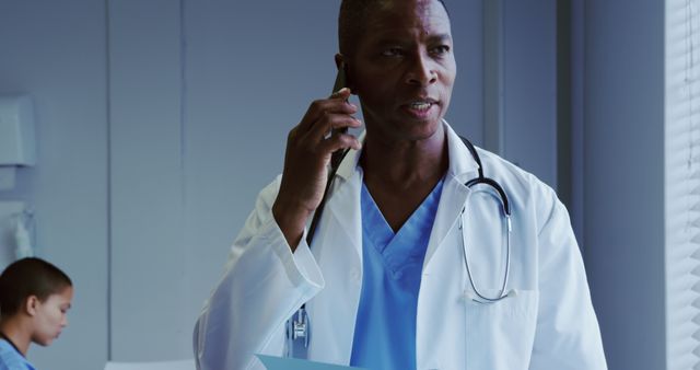 Focused Doctor Talking on Phone in Hospital - Download Free Stock Images Pikwizard.com