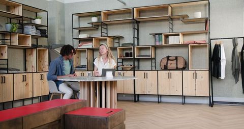 Diverse business duo collaborating at stylish workplace