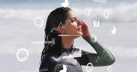 Surfer in wetsuit touching temple on shore with ar hud surf analytics, performance data