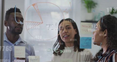 Diverse team collaborating with digital data in modern office
