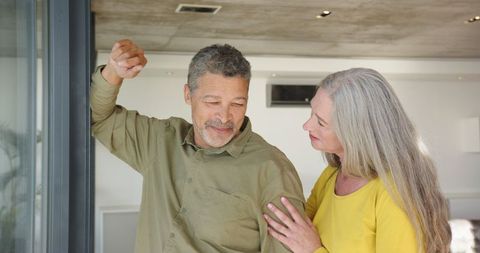 Senior Couple Sharing Special Moment by Modern Living Room Entryway