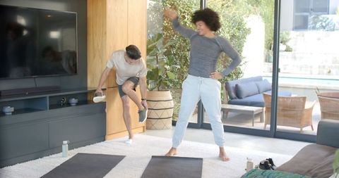 Two Men Warming Up for Exercise at Home in Modern Living Room