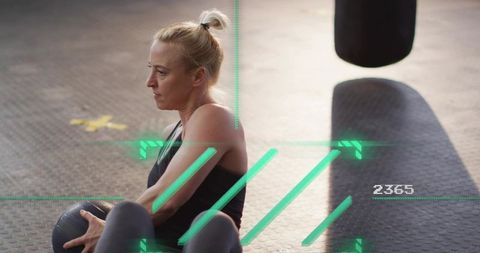 Female athlete holding medicine ball during core workout with ar hud overlay