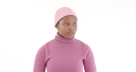 Thoughtful woman wearing pink sweater and beanie