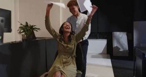 Colleagues laughing and having fun in modern office