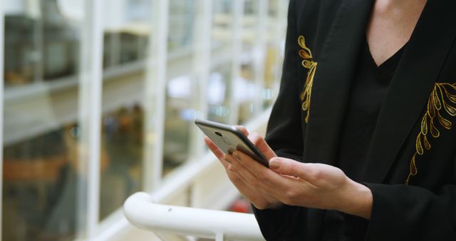 Businessperson Checking Smartphone in Modern Office Building - Download Free Stock Images Pikwizard.com