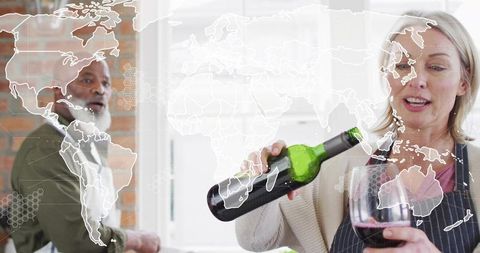 Pouring Red Wine During Home Cooking Date Night in Bright Modern Kitchen