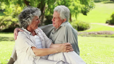 Happy Senior Couple Embracing in Park