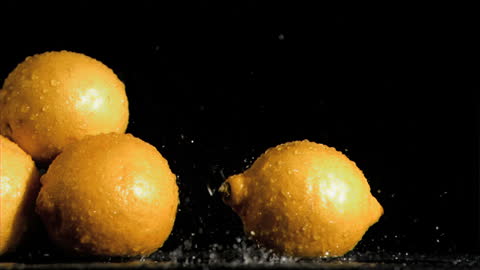 Fresh Lemons Splashing in Water on Black Background