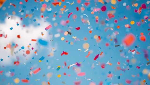Vibrant Confetti Exploding Against Clear Blue Sky