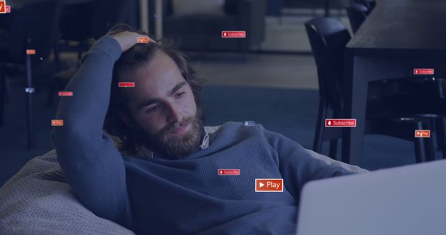 Man is relaxing on a bean bag while watching a screen, surrounded by various subscription and play icons. Perfect for illustrating themes related to online media consumption, technology, or modern lifestyle. Can be used for advertisements, blog posts, and articles about streaming services, relaxing at home, and internet habits.