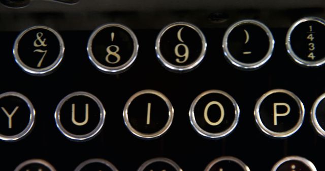 Close-up of vintage typewriter keys, showcasing the classic design and layout of letters and symbols. The image evokes nostalgia for traditional writing tools and the tactile experience of typing on mechanical keys.
