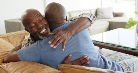 Warm embrace in living room: father and son bonding moment