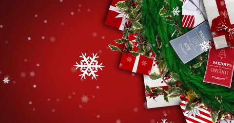 Festive Christmas Presents with Falling Snow on Red Background