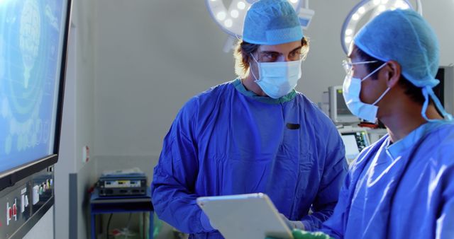 Two Surgeons Discussing Procedure in Operating Room - Download Free Stock Images Pikwizard.com