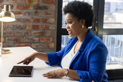 Professional Woman Using Tablet in Modern Office Setup