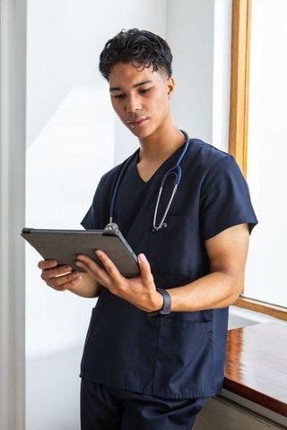 Young Healthcare Professional Using Tablet for Modern Medical Practice