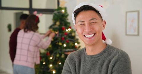 Festive Asian Man Celebrating Christmas with Friends