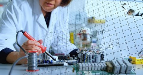 Female Scientist Conducting Electronics Research with Mathematical Models