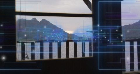 Framing fjord dusk through wooden deck railing with futuristic blue data overlay