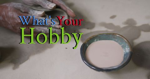 Pottery enthusiast shaping clay with hands