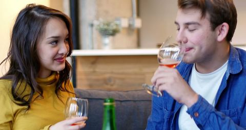 Young Couple Enjoying Wine Together in Cozy Living Room - Download Free Stock Images Pikwizard.com