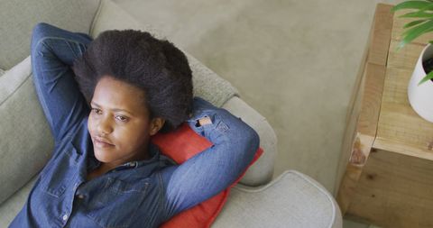Relaxed Woman Enjoying Comfort on Living Room Sofa