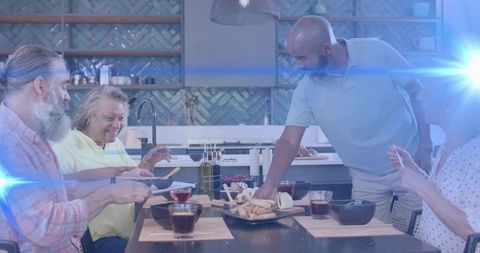 Multigenerational group sharing bread and laughter around modern kitchen dining table
