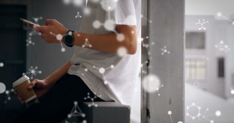 Young Adult with Coffee and Smartphone Reflecting On Digital Life