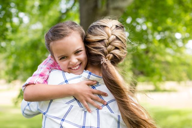 Happy Girl Embracing Mother in Park - Download Free Stock Photos Pikwizard.com
