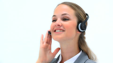 Professional Woman Smiling While Using Headset in Call Center