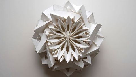 Modular white paper kusudama sculpture featuring radial floral rosette and angular panels