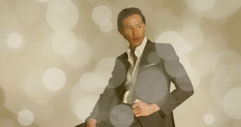 Fashionable asian man suit modeling studio setting