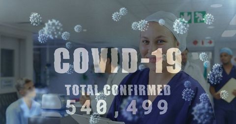 Healthcare Workers Smiling Amid COVID-19 Statistics in Hospital Setting