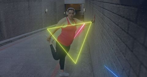 Caucasian woman stretching in urban environment with neon shapes