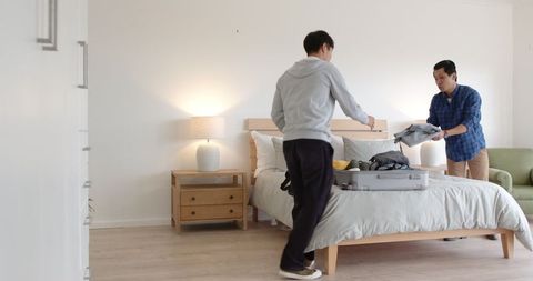 Father and Son Packing Suitcase for Travel Adventure
