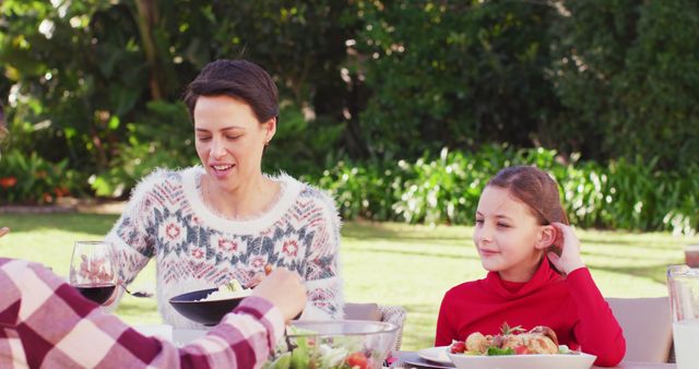 Family enjoy outdoor meal in sunny garden with fresh salad and wine - Download Free Stock Images Pikwizard.com