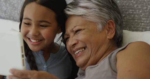 Grandmother and Granddaughter Sharing Laughs While Using Tablet - Download Free Stock Images Pikwizard.com