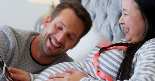 Happy Expecting Couple Enjoying Ultrasound Picture in Bedroom - Download Free Stock Images Pikwizard.com