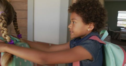 Diverse friends walking together in school hallway