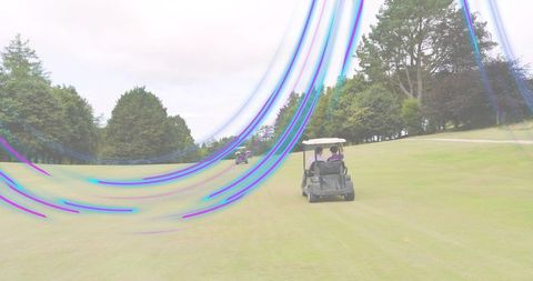 Golfers riding canopy cart along fairway with purple-blue light trails and scenic treeline