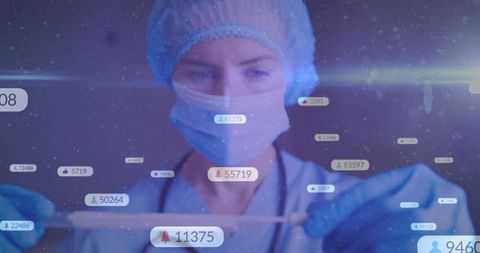 Female clinician in ppe interacting with holographic medical interface and live alerts