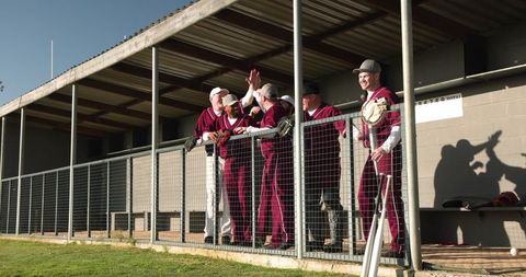 Baseball Teammates Celebrating Leisurely in Dugout