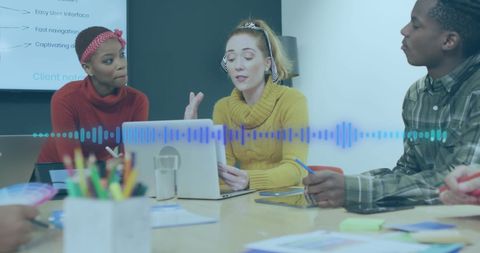 Diverse team collaborating with sound interface in modern office