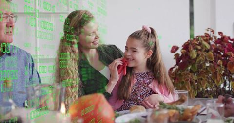 Multigenerational family wiping daughter's cheek during cozy mealtime with digital overlay