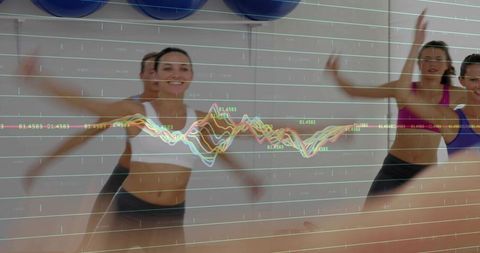 Women jumping in group cardio studio with multicolor line graph fitness metrics overlay